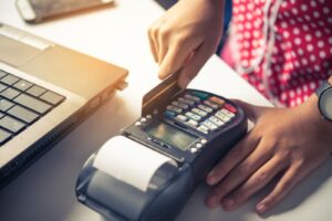 person using a credit card POS machine