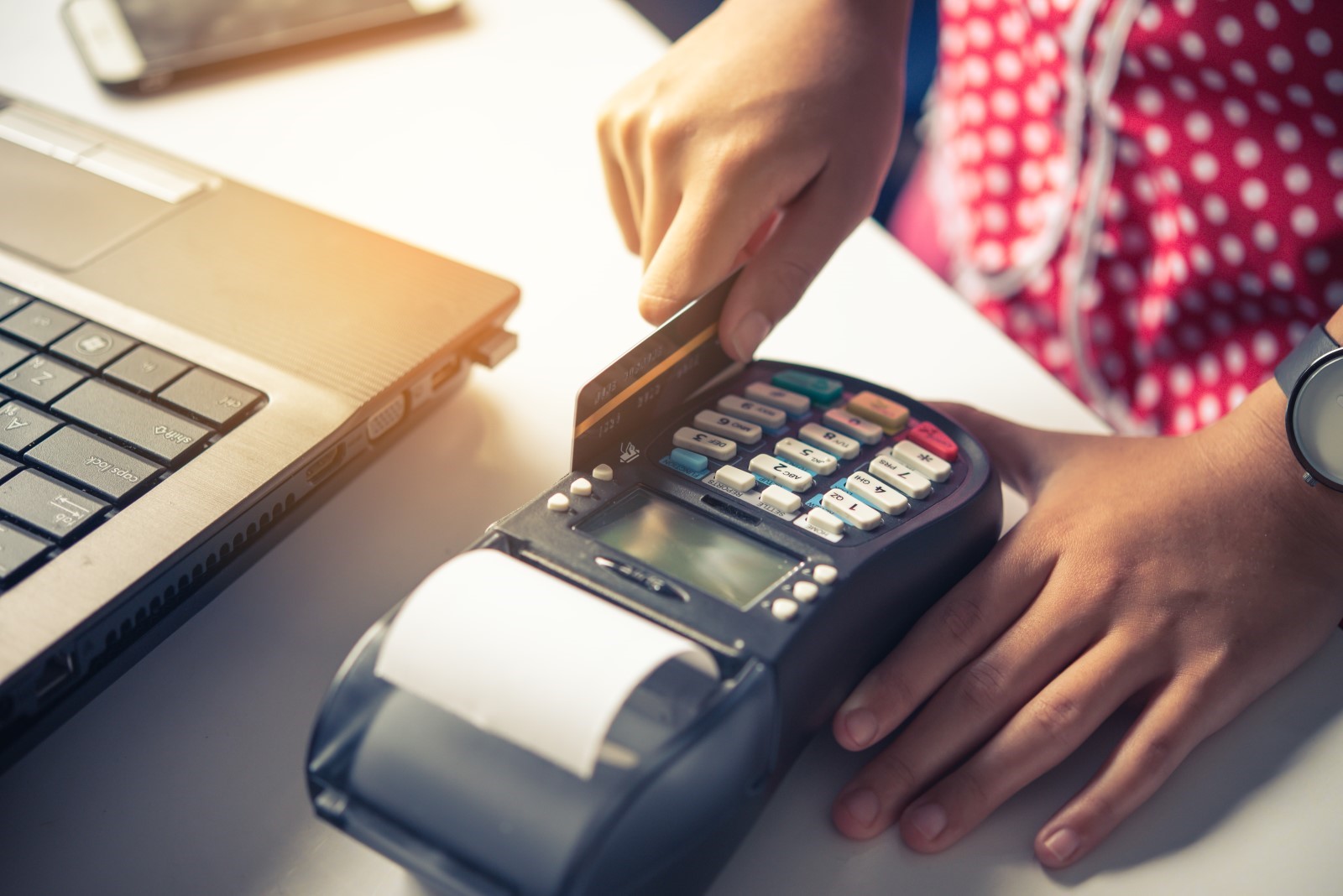 person using a credit card POS machine